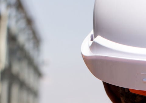 Picure looking behind a person wearing a Konecranes branded safety helmet
