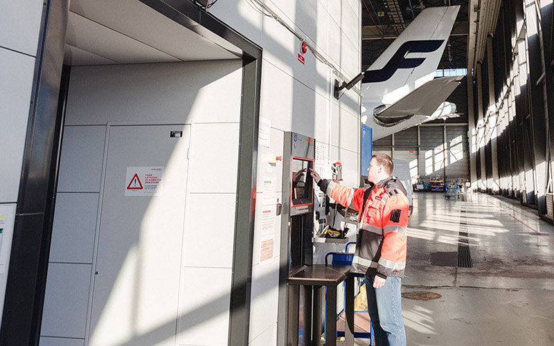 Finnair worker uses touchscreen on Agilon system