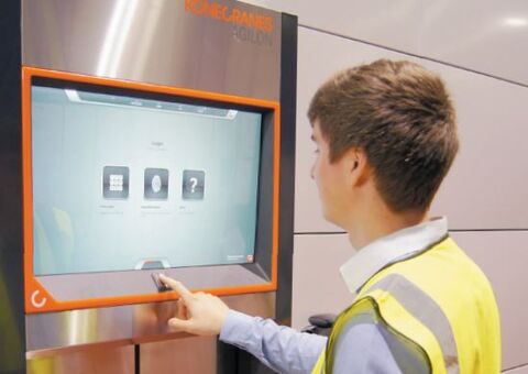 The picture show one Forward Industrial staff logging onto the control panel  with their fingerprint and receiving an item through the Agilon delivery hatch.