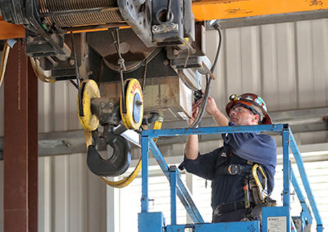Konecranes technician performs preventive maintenance on hoist