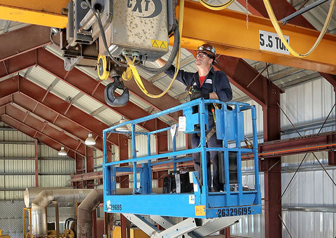 Technician works on overhead crane