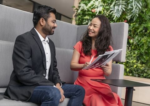 Man and woman chatting in office environment