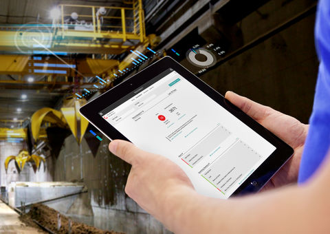 Person holding a tablet in factory