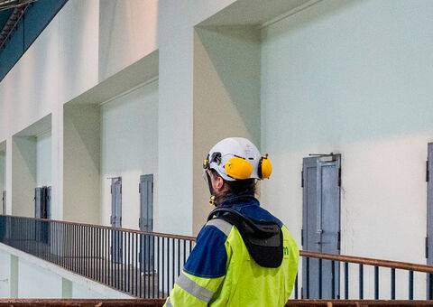 Crane operator viewing an overhead crane at hydro power plant