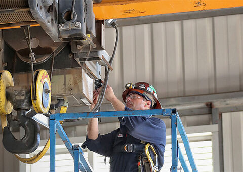 Technician inspecting crane