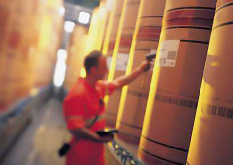 Man scanning packages in warehouse