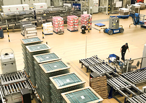 Worker in warehouse with large pallets