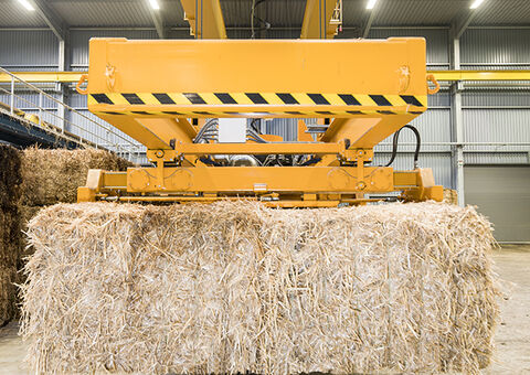 Straw bale lifted by crane