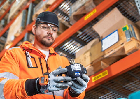 Worker holding part in distribution center