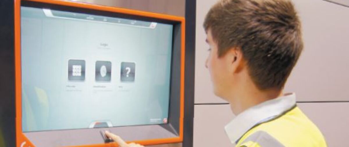 The picture show one Forward Industrial staff logging onto the control panel  with their fingerprint and receiving an item through the Agilon delivery hatch.