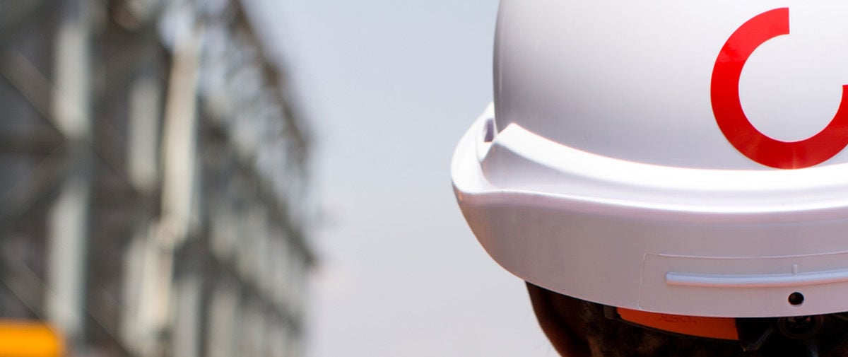 Picure looking behind a person wearing a Konecranes branded safety helmet
