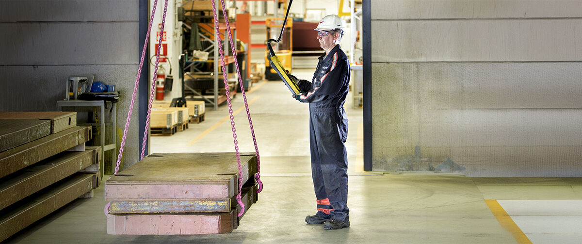 Technician performs load test on overhead crane