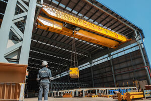 Vard employee operating crane
